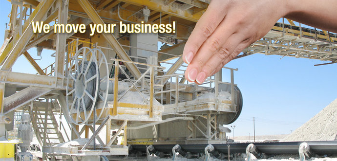 A hand pushes a stacker with a mounted motor-driven reel in a mining ambient.